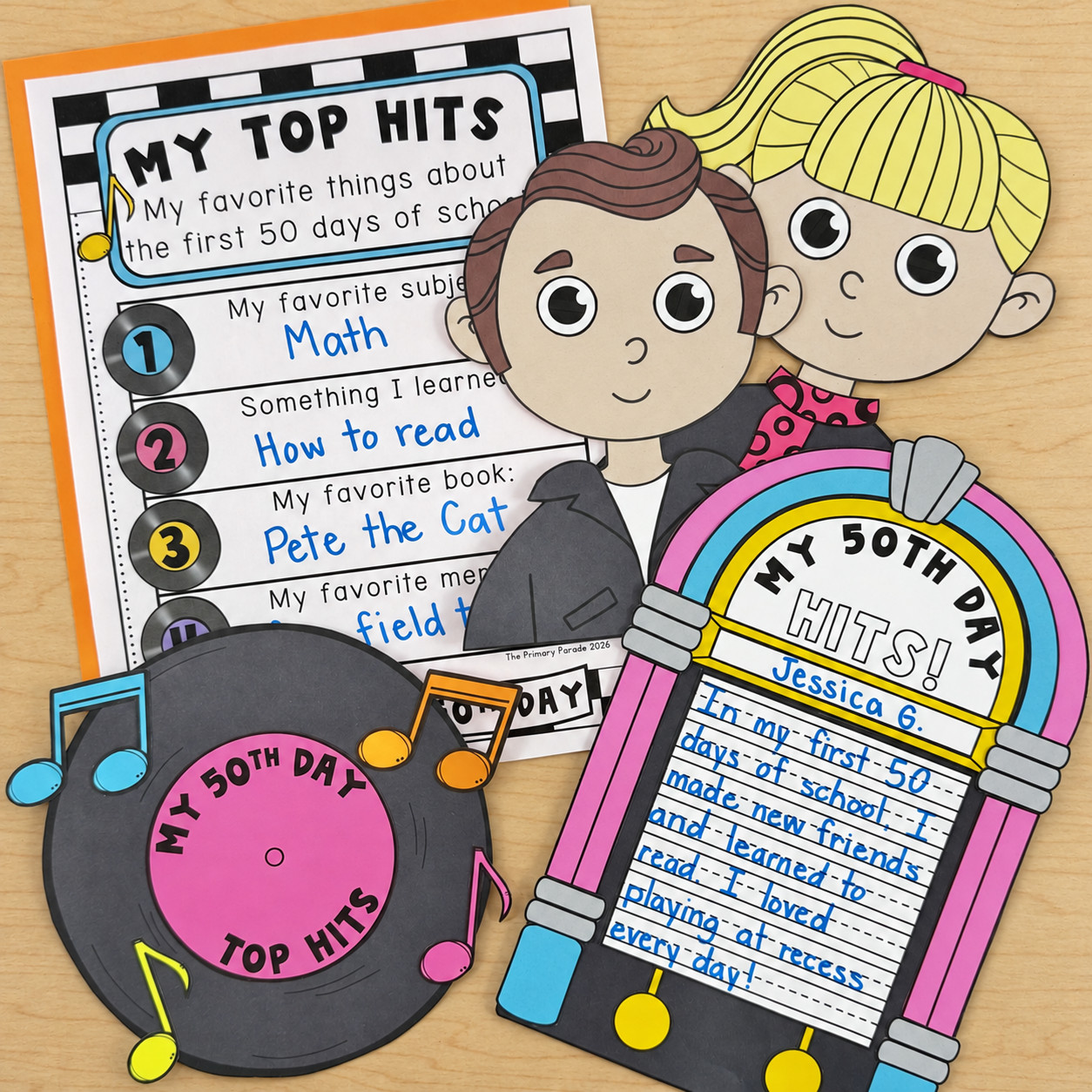 Retro boy and girl, colorful jukebox, vinyl record craft, and My Top Hits writing page arranged on a wooden desk.