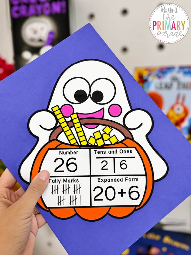 Halloween math craft showing a ghost holding a pumpkin basket with base ten blocks for kindergarten and first grade place value and number sense