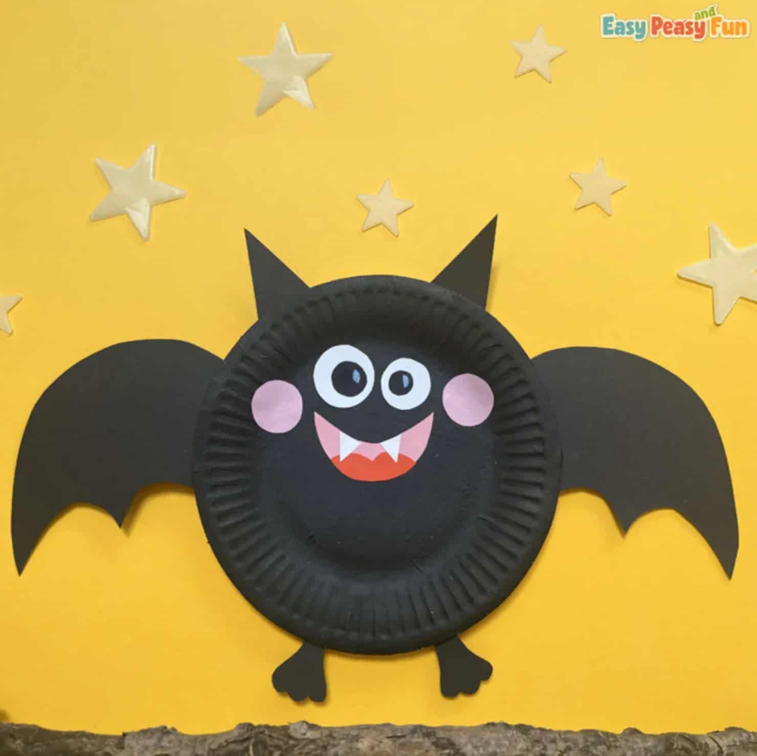 Black paper plate bat with pink cheeks and paper wings