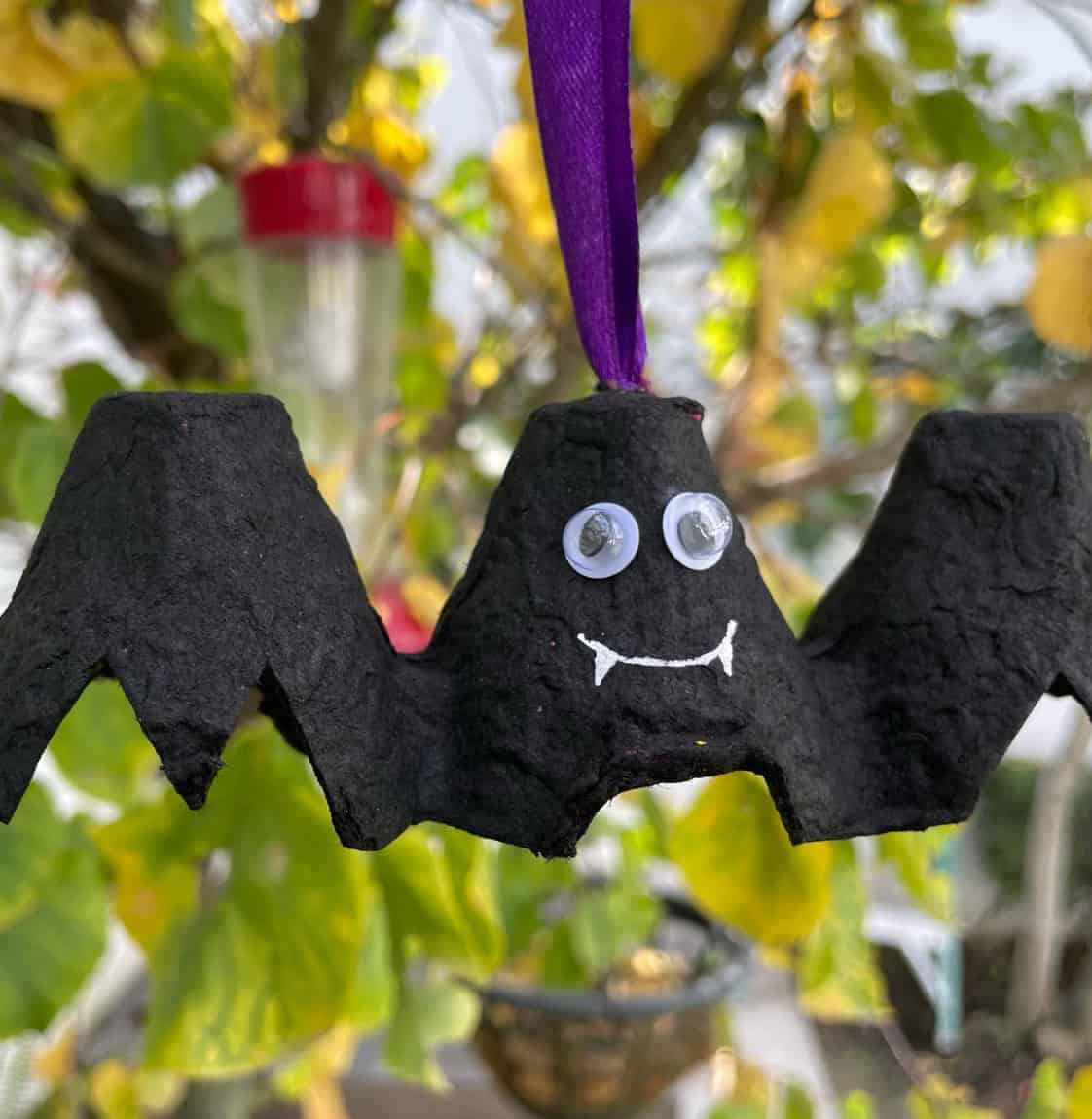 Black egg carton bat hanging on ribbon