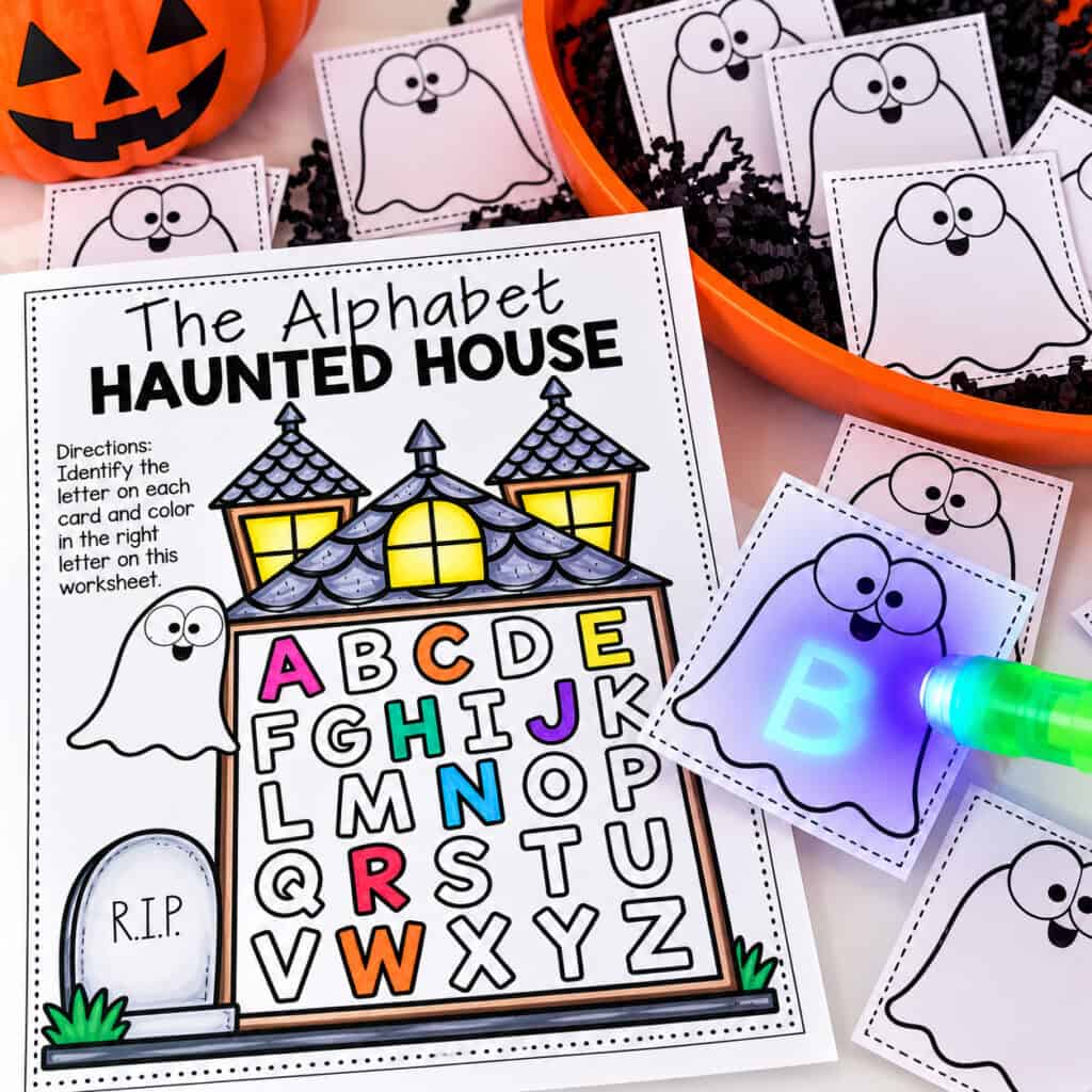 Halloween alphabet activity with a haunted house letter worksheet, ghost cards, and a UV flashlight revealing a hidden letter B.