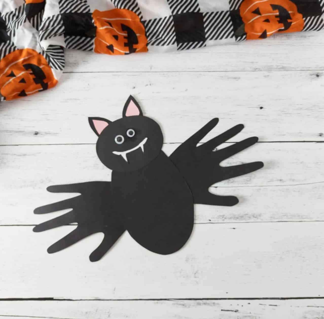 Black paper bat with handprint wings